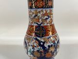 a vase that is sitting on a white surface