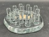 a glass candle holder that has a lot of candles inside of it