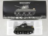 a small toy tank in a plastic container on a table