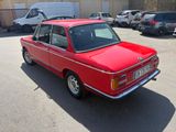 a red car that is parked in a parking lot