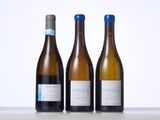 three bottles of wine that are sitting on a table