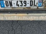 a dirty license plate on the back of a car
