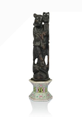 a statue of a man holding a bear on a pedestal