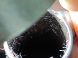 a person holding a metal pipe with a hole in it