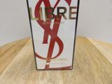 a box of perfume sitting on a wooden table