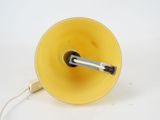a yellow light that is on top of a white table