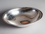 a silver bowl that is sitting on a table