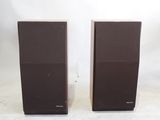 two speakers sitting on top of a white surface next to each other
