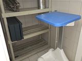 a blue tray sitting on top of a cart in a bathroom