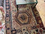 an image of a living room with couches and rugs