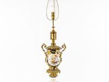 an antique brass and porcelain lamp with a glass shade