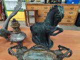 a statue of a horse and a vase on a table