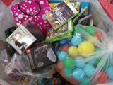 a plastic bag full of toys and games on a table