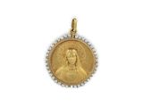 a close up of a gold medal with pearls on a white background