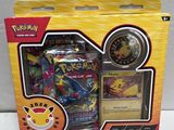 the box contains a pokemon trading card and a pokemon watch