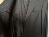 a picture of a black suit hanging on a hanger