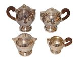 four pieces of silver tea and coffee set on a white background