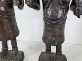 two figurines of a man and a woman holding a knife and fork