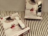 boxes on a bed with a woman ' s shirt and a man ' s shirt