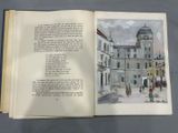 an open book with a picture of a building in the background