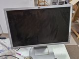 a computer monitor sitting on top of a white desk