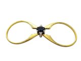 a close up of a gold ring with a black diamond