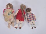 three dolls that are laying next to each other