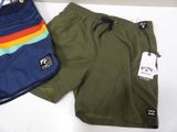 two pairs of men ' s swim shorts and a bag on a table