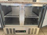 an open refrigerator that is sitting on a tile floor
