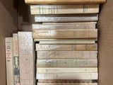 a box full of books that are stacked on top of each other