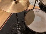 a drum set up in a recording studio with a microphone on the floor