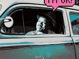a man sitting in the driver ' s seat of a car