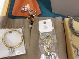 a tray that has a bunch of jewelry inside of it