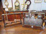 a wooden table with a glass case and a clock on it