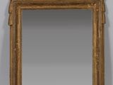 an image of a gold framed mirror with a bird design on it
