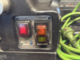 a close up of a green hose connected to a machine