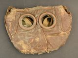 an old baseball glove with two holes in it