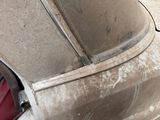 an old car that has been rusted and is sitting in the garage