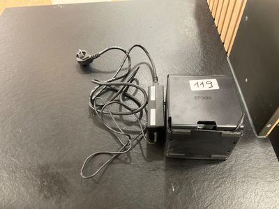 an image of a table with a printer and a charger on it