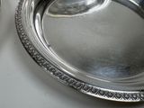 a silver plate with a spoon and a spoon on it