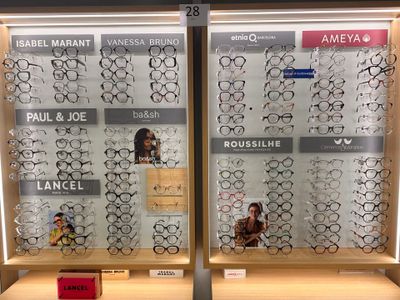 two rows of glasses on display in a store window