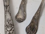 three spoons and a fork sitting on a table
