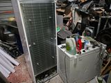 a refrigerator and a refrigerator freezer in a messy room