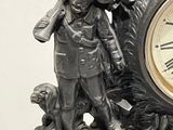 a clock with a statue of a man and a dog on it