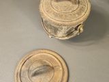 a small wooden object on a table next to other items