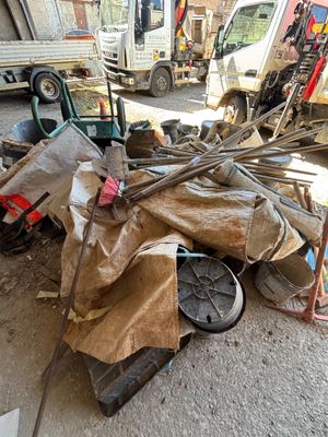 un tas de vieilleries par terre, à côté d'un camion