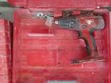 a red box with a drill in it and some other tools in it