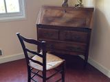 a chair and a desk in a room with a window