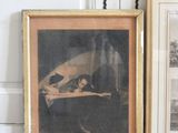 two framed pictures of a dog and a cat on a table