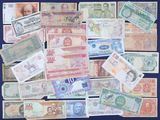 many different types of foreign currency on the table